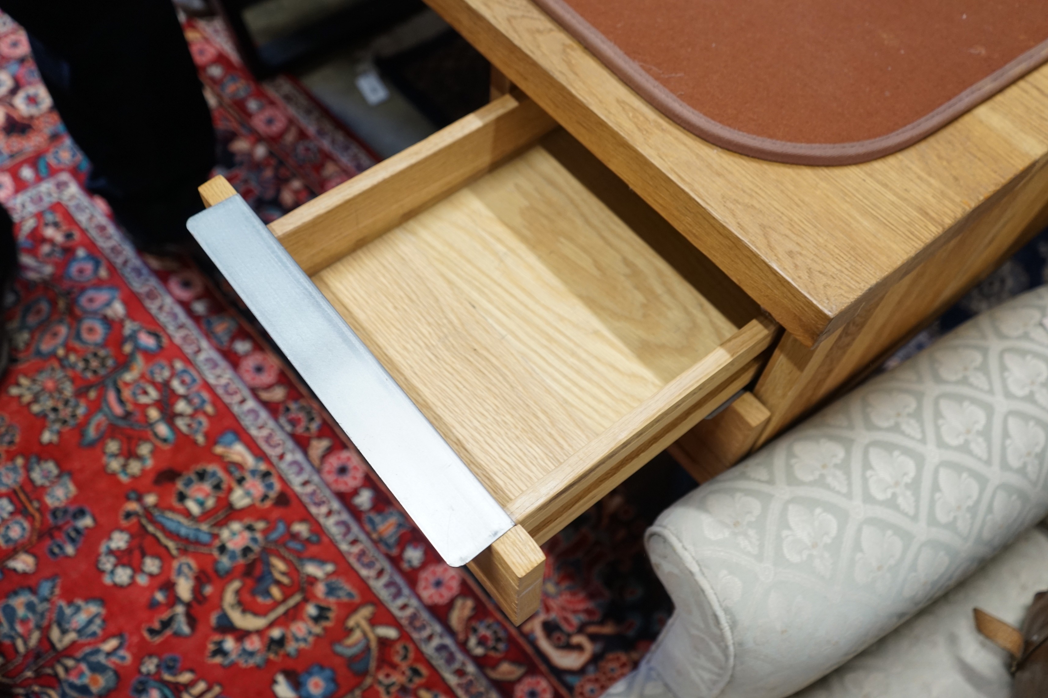 A contemporary oak and wrought iron kneehole desk, length 135cm, depth 67cm, height 76cm